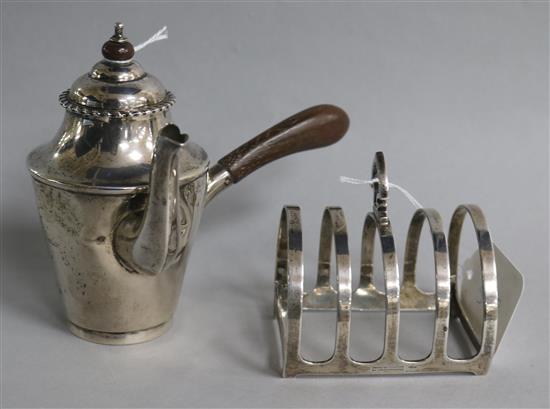 A late Victorian silver bachelors cafe au lait pot and a later silver toastrack.